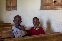 Only two girls attending school, sitting apart from the boys.