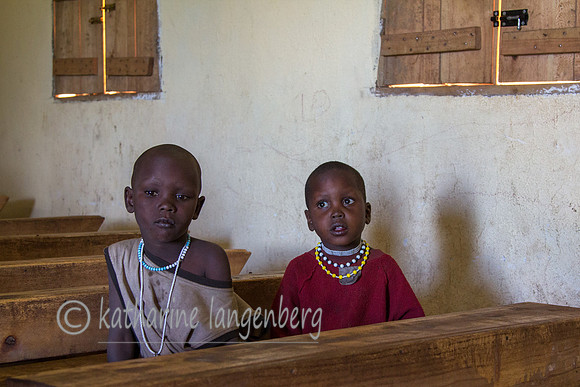 Only two girls attending school, sitting apart from the boys.